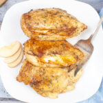 Apple and Muenster Stuffed Chicken Breast on white serving plate.