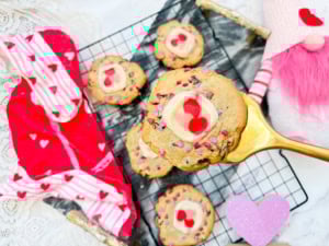 Valentine Chocolate Chip and Sugar Cookies on cooling rack with one of them on a spatula close up.