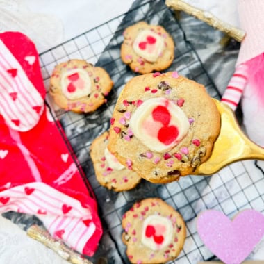 Valentine Chocolate Chip and Sugar Cookies on cooling rack with one of them on a spatula close up.
