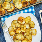 Sheet Pan Garlic Herb Potatoes on a white plate with fork