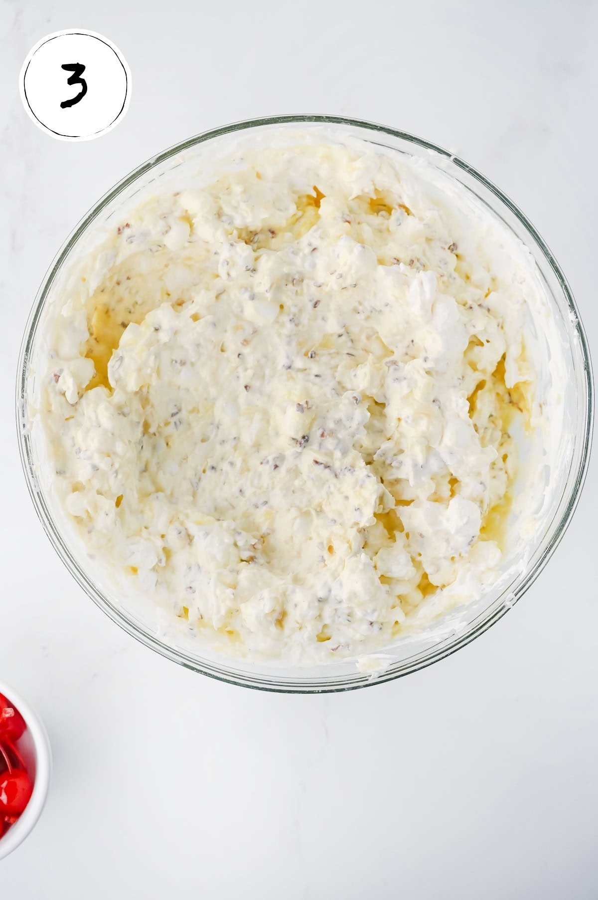 pina colada marshmallow salad mixed in bowl.