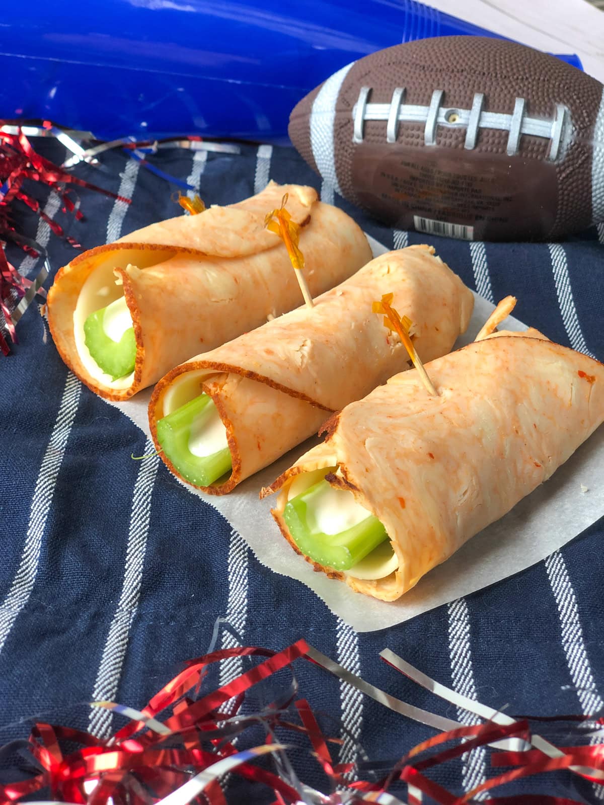 Buffalo Chicken RollUps with celery, provolone and blue cheese dressing.