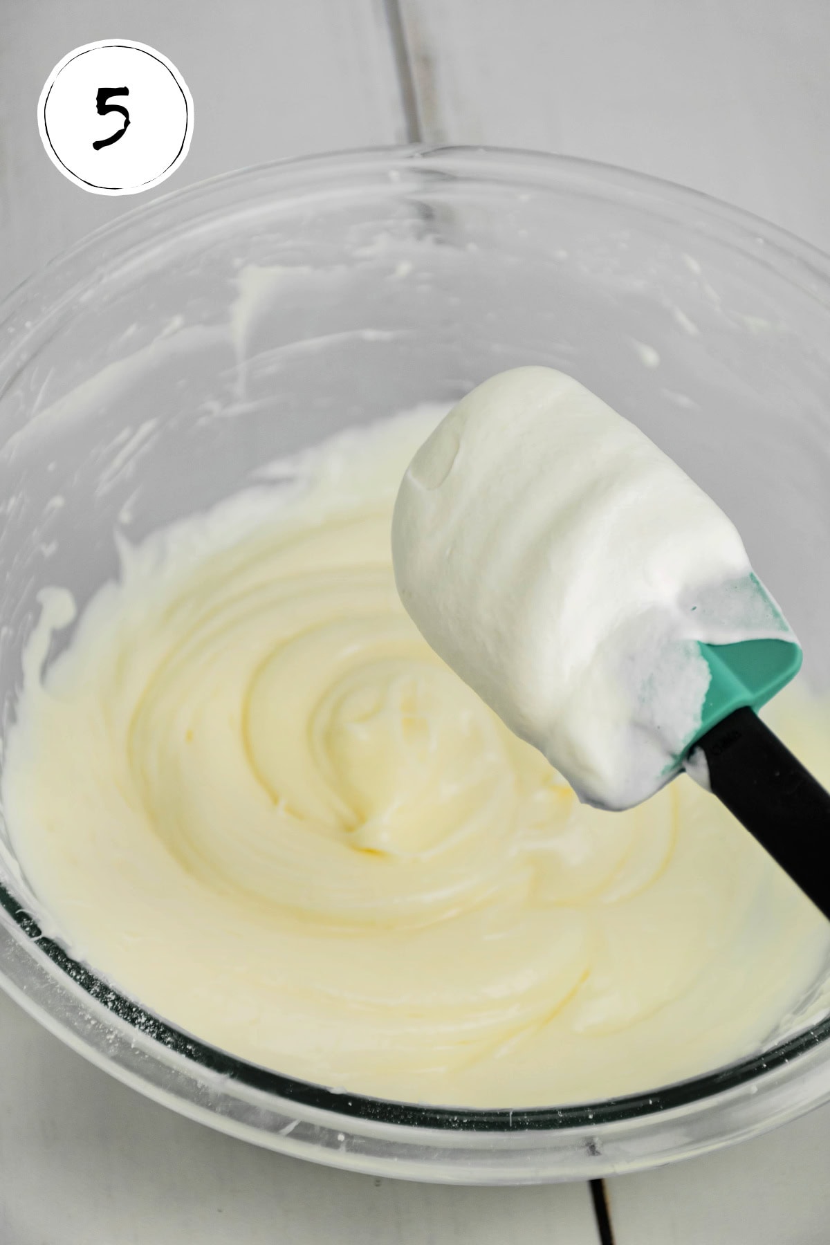 Combining whipped cream into filling for Mini No Bake Cheesecakes.
