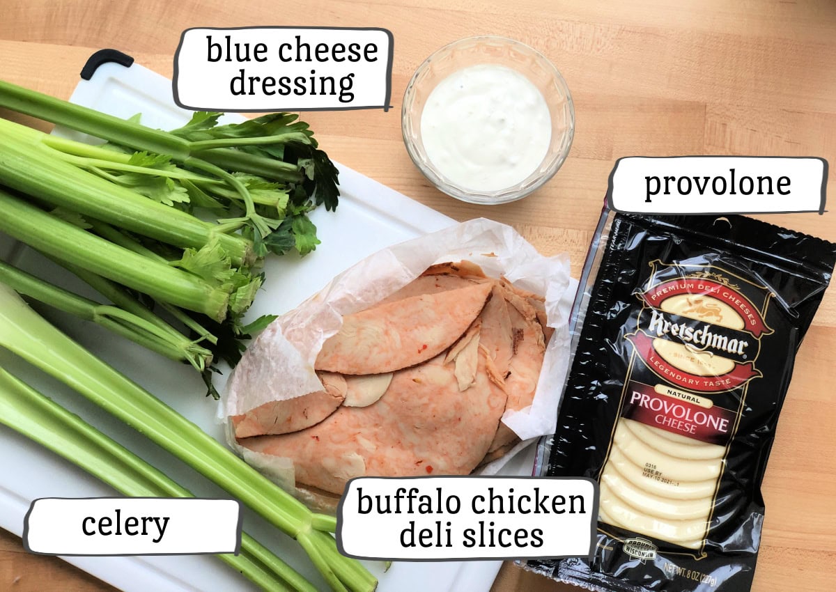 buffalo chicken roll ups ingredients including deli buffalo chicken, provolone, celery and blue cheese dressing.