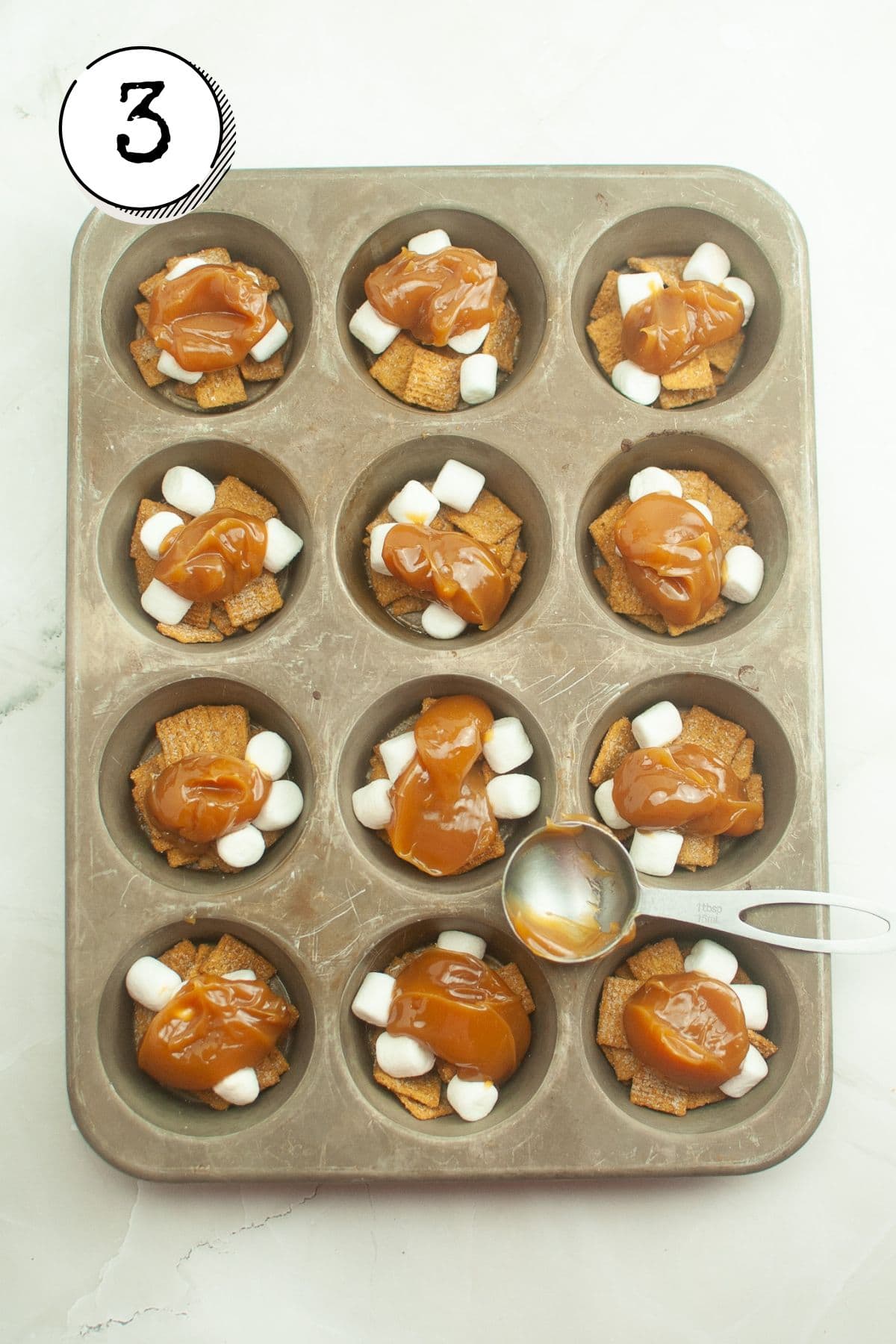 Spooning 1 tablespoon of caramel onto each cup and freezing for approximately an hour, or until caramel has set.