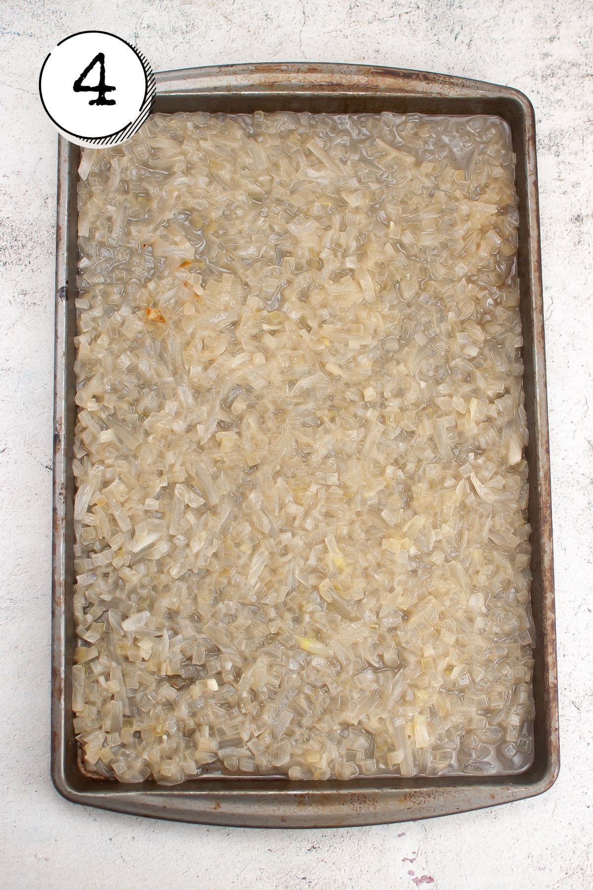 adding the onions and juices, spreading them out across the entire baking sheet
