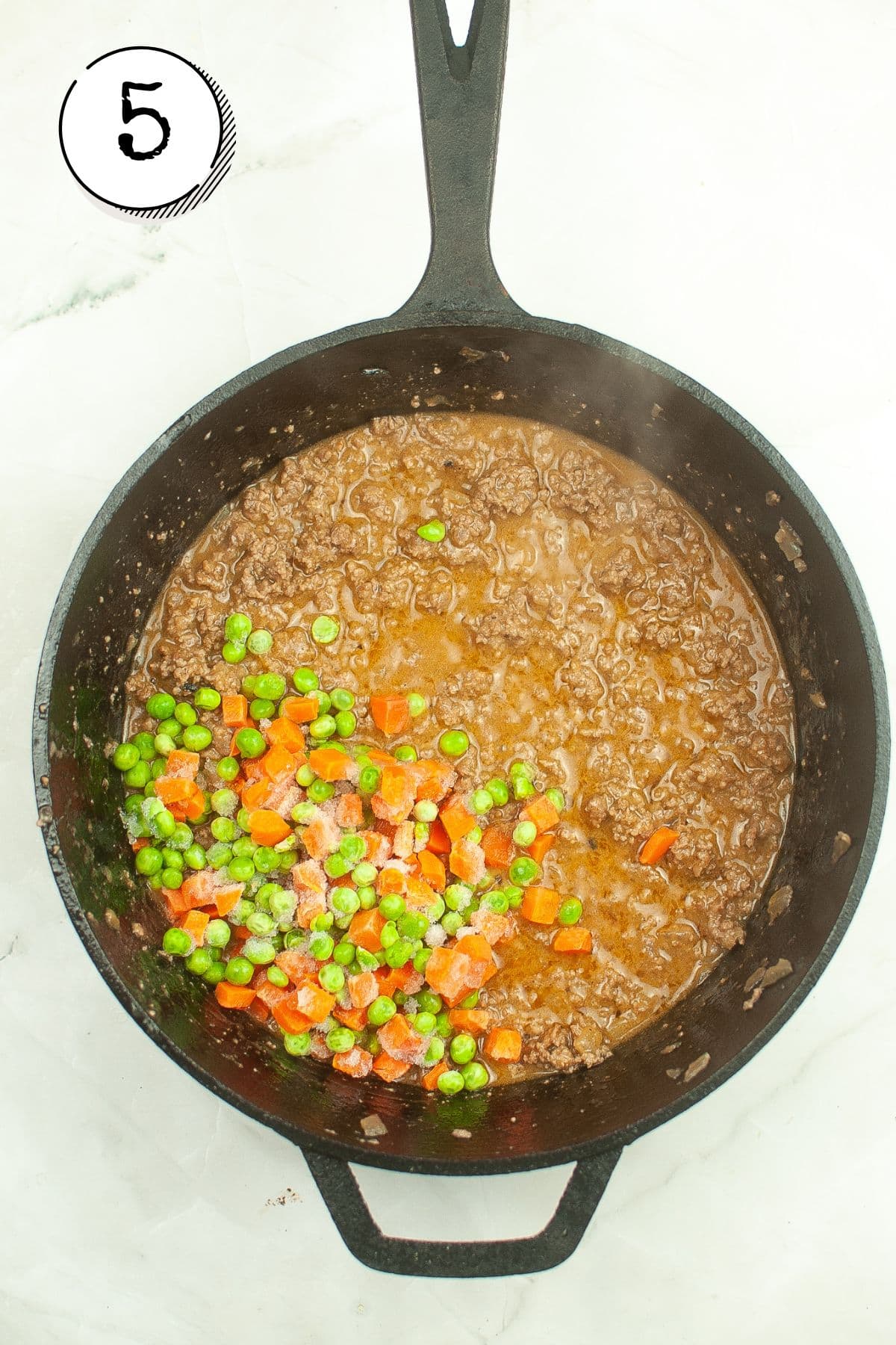 Adding the broth and vegetables.