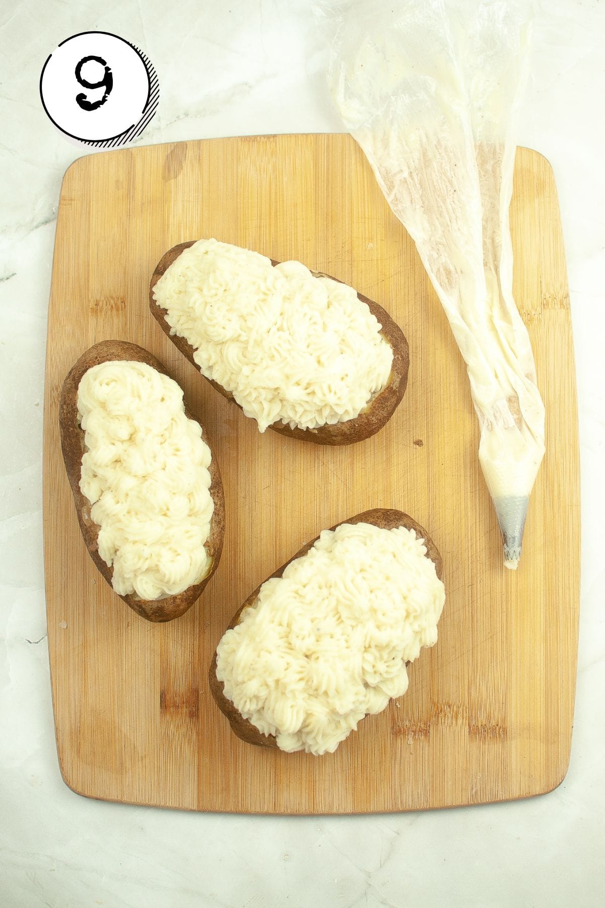 Piping the potatoes on top of the meat.