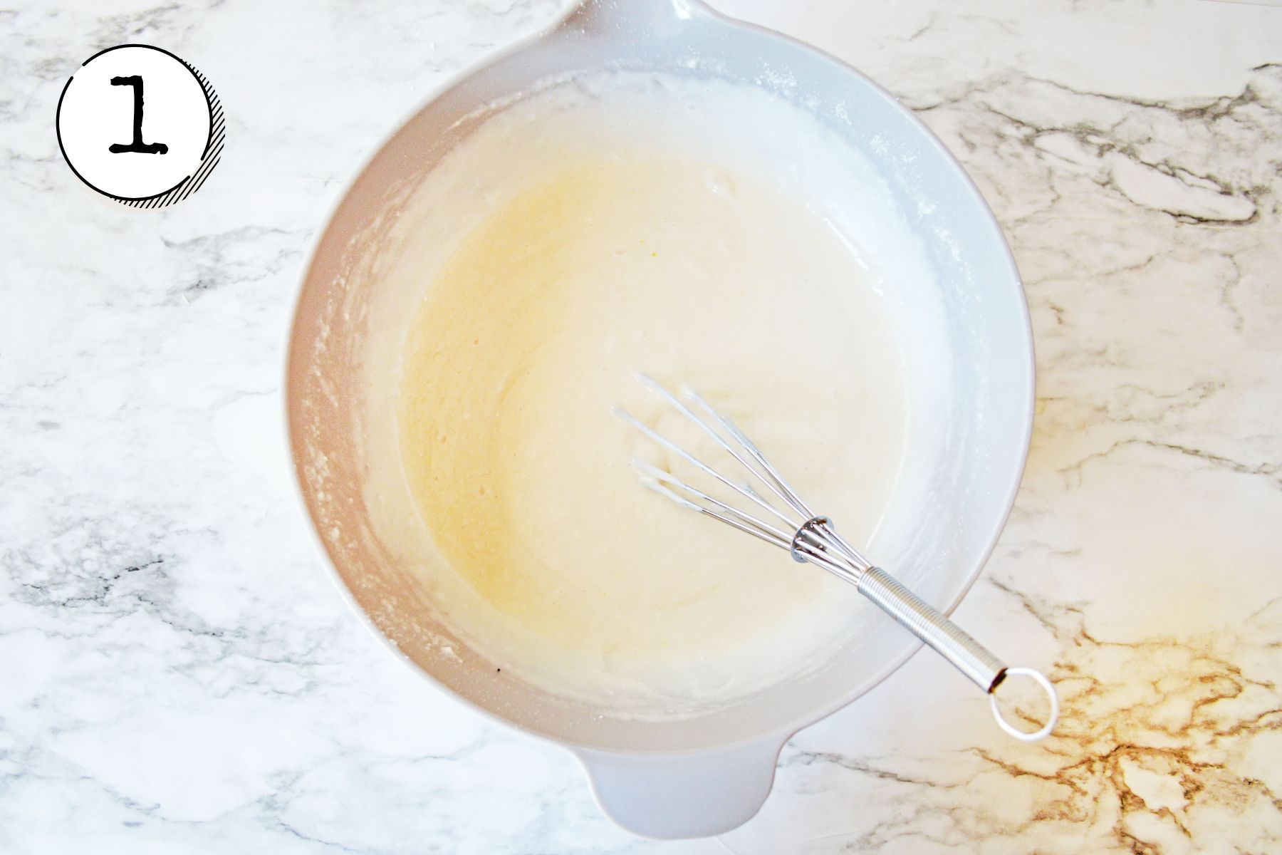 Preparing the cake mix, whisking until batter is smooth.