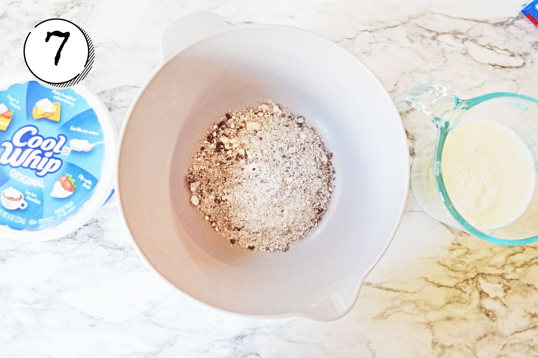 adding the second package of Oreo pudding mix and combining with milk.