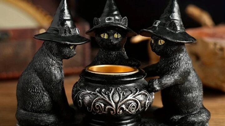 halloween witch cat sculpture with 3 black cats wearing witch hats around cauldron.