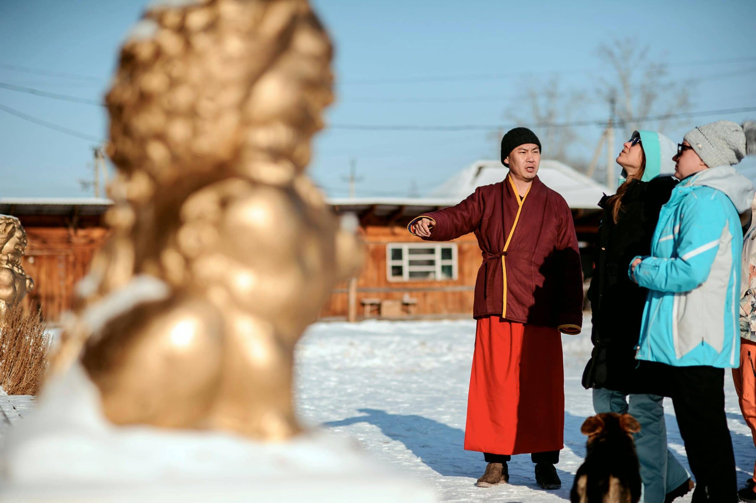 tour guide showing statue in snow