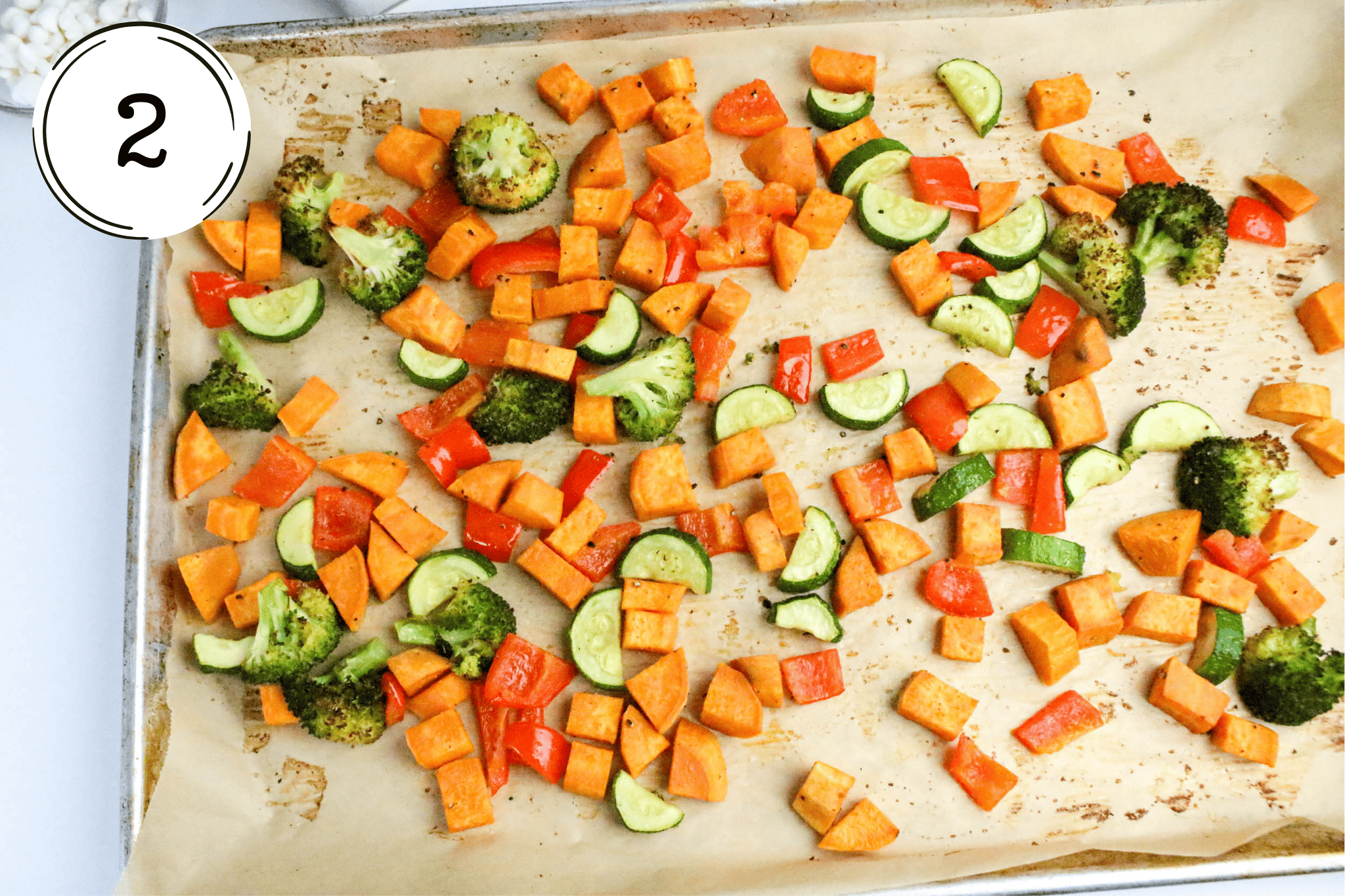 spreading the veggies on baking sheet