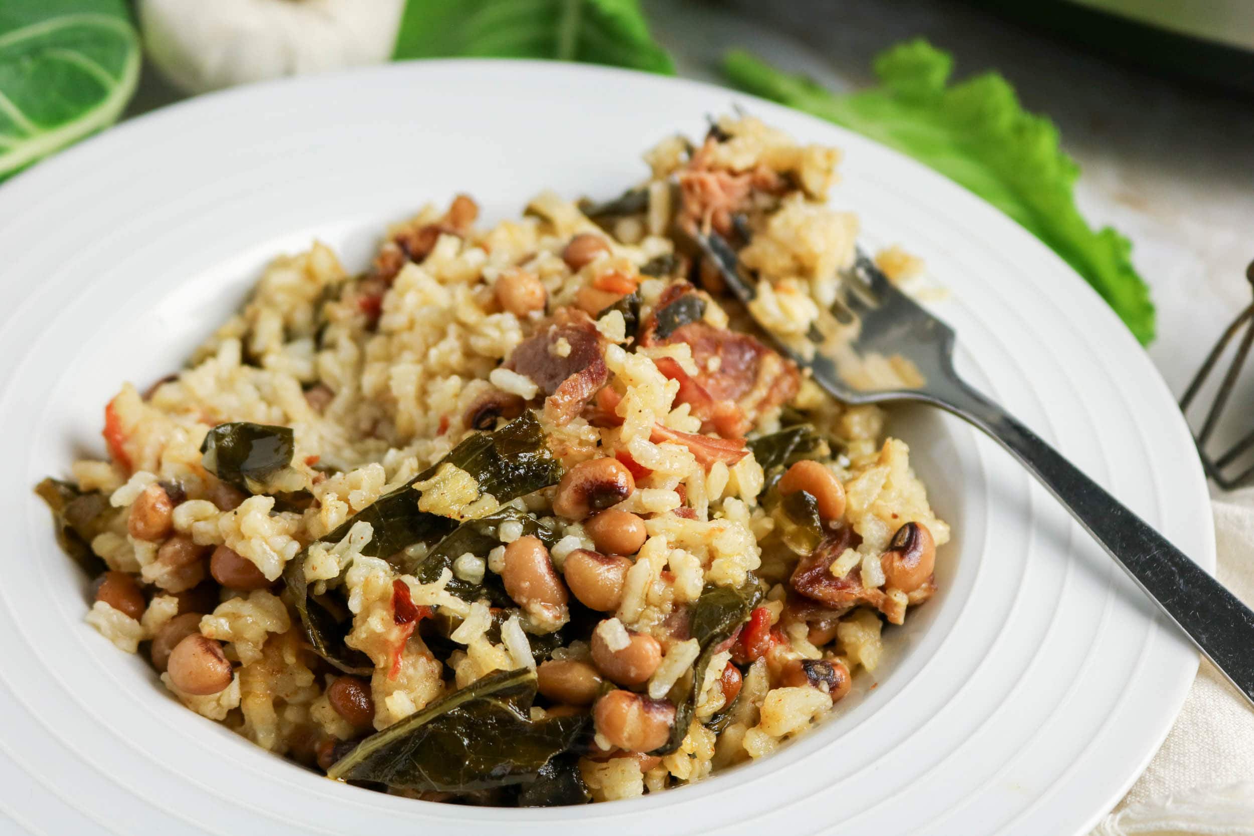 Slow Cooker Black Eyed Peas Collards and Rice in a plate focused on camera