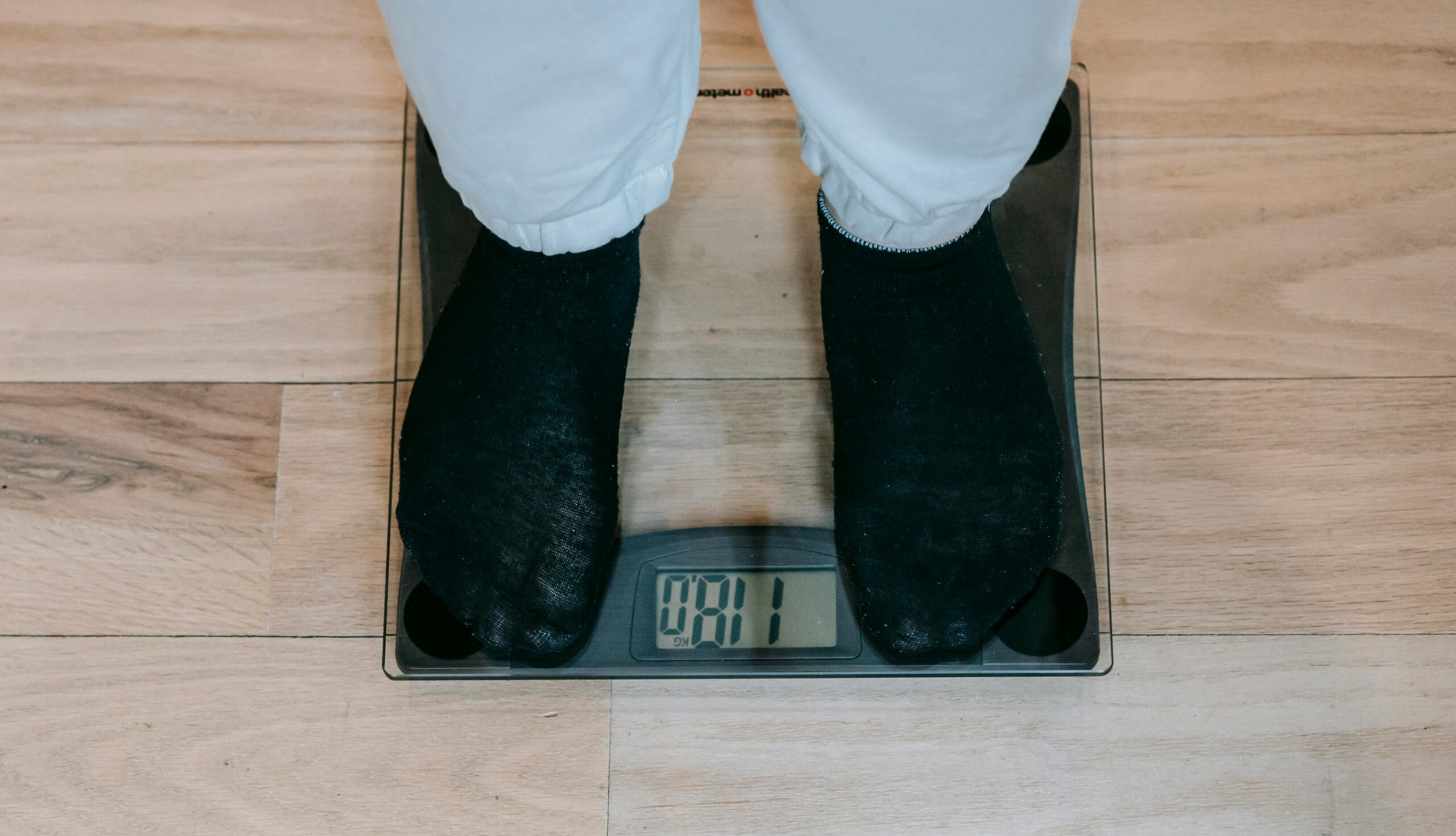 person with black socks on weighing scale