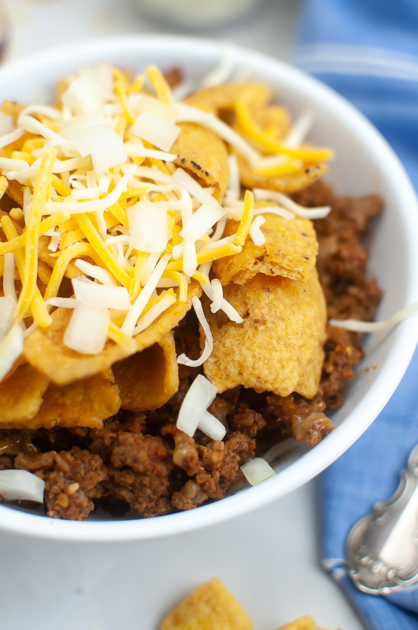 air fryer frito pie in a white bowl and blue table cloth