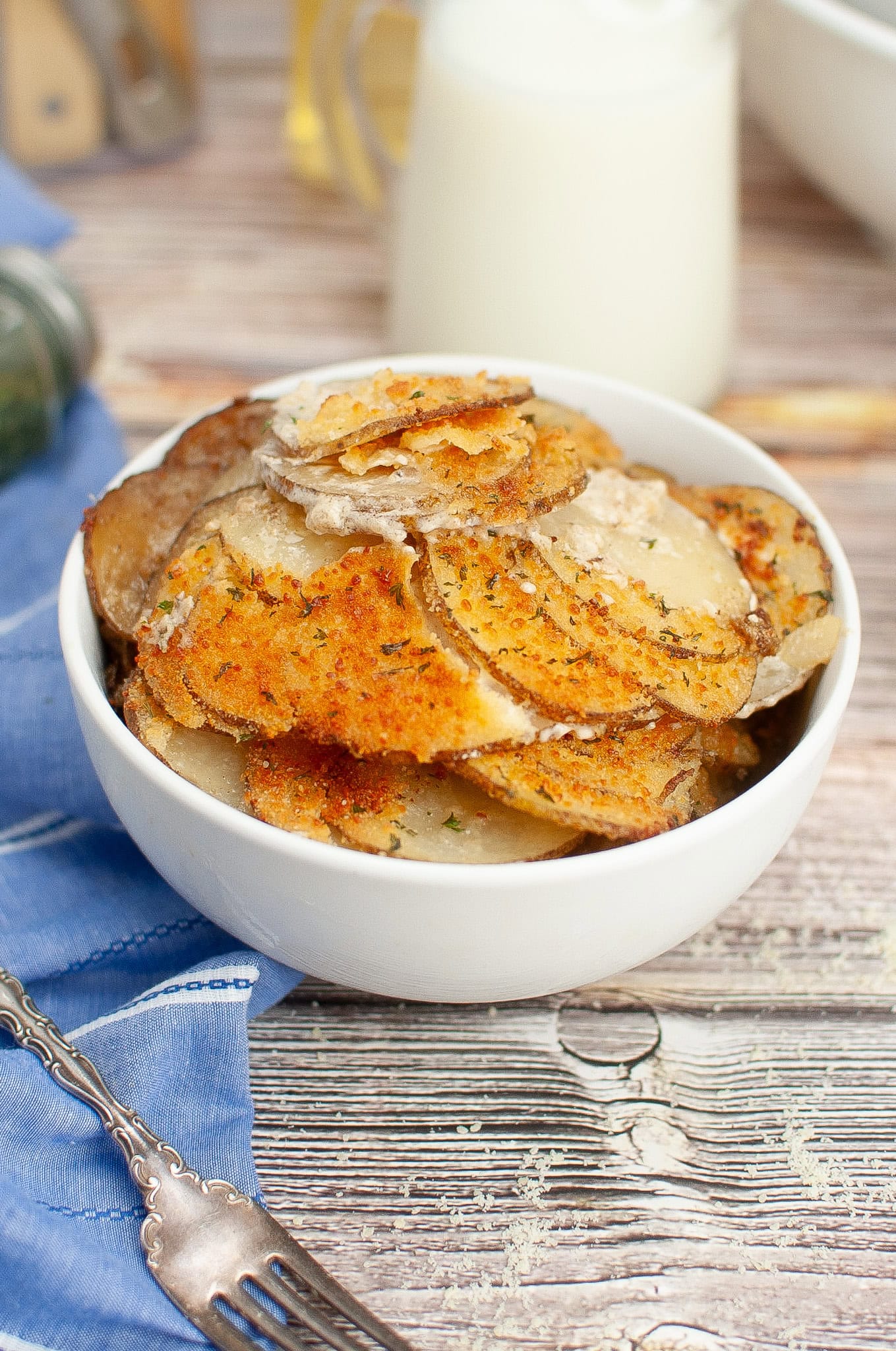 Au Gratin Potatoes Crisp Parmesan in a bowl with spoon
