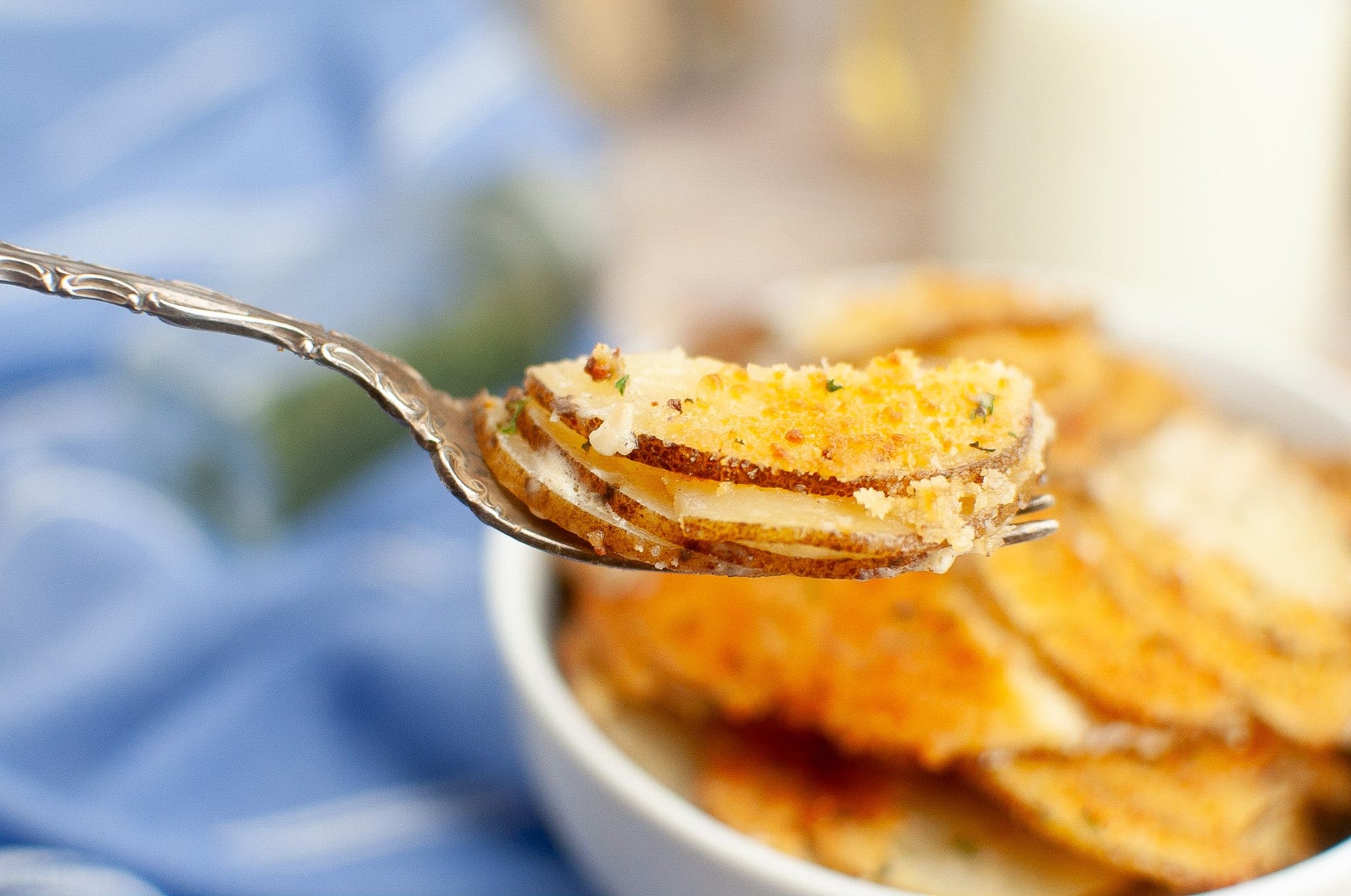 a spoonful of Au Gratin Potatoes Crisp Parmesan 
