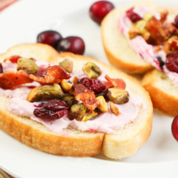 Bacon Pistachio and Cranberry Cream Cheese Crostini in a plate